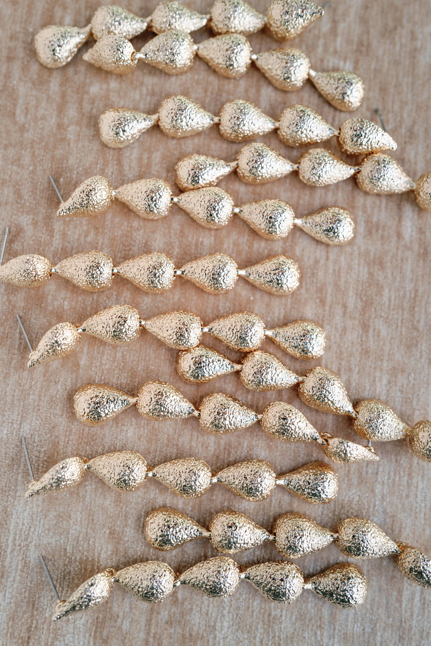 Swingy Textured Gold Teardrop Cascade Statement Earrings